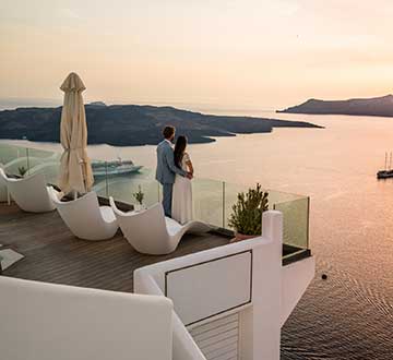 Man and woman enjoying sunset at a luxury destination